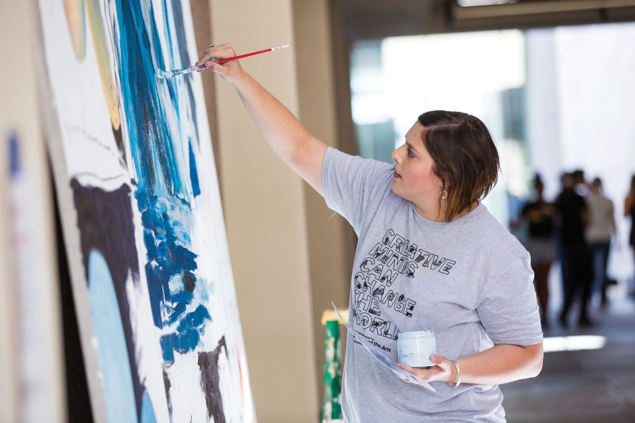 Drawing professor Heidi Hogden adds to a speed mural hosted by associate professor Mark Polio