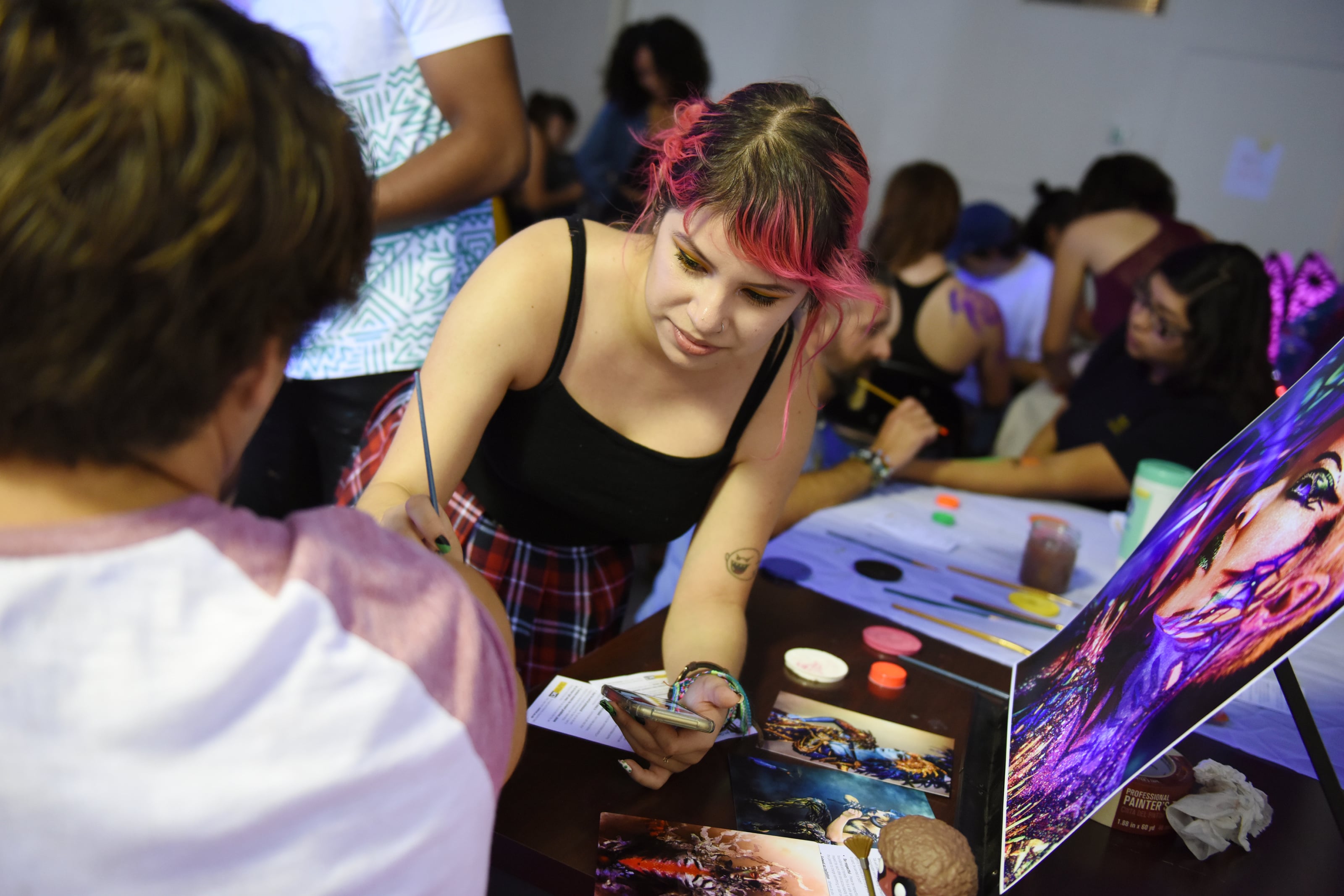 student painting on another student's arm