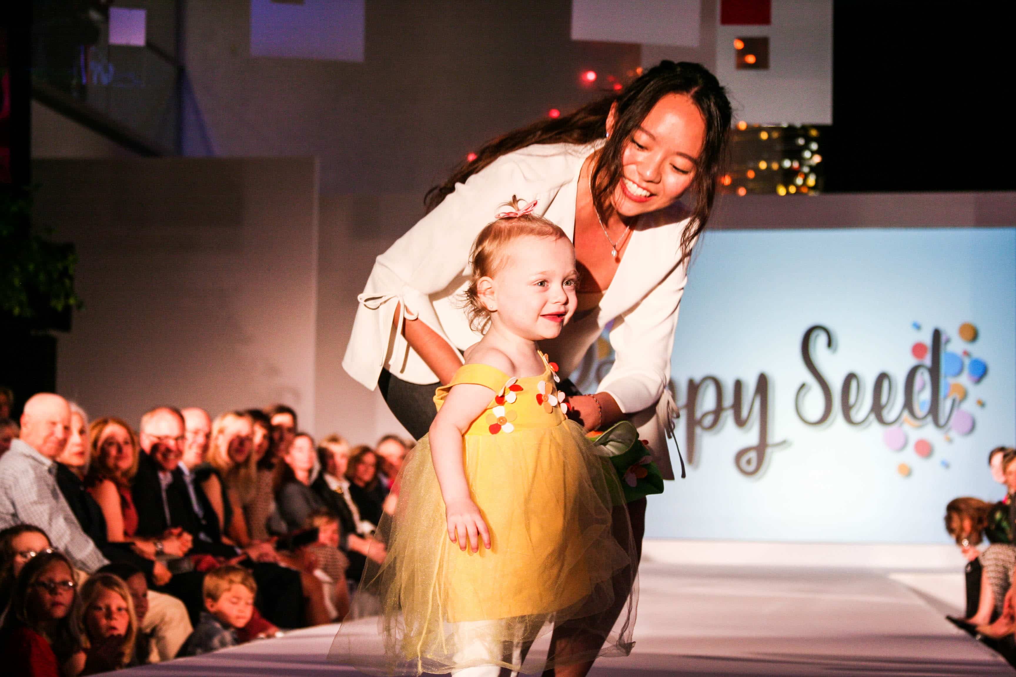 toddler girl in super hero costume on fashion runway