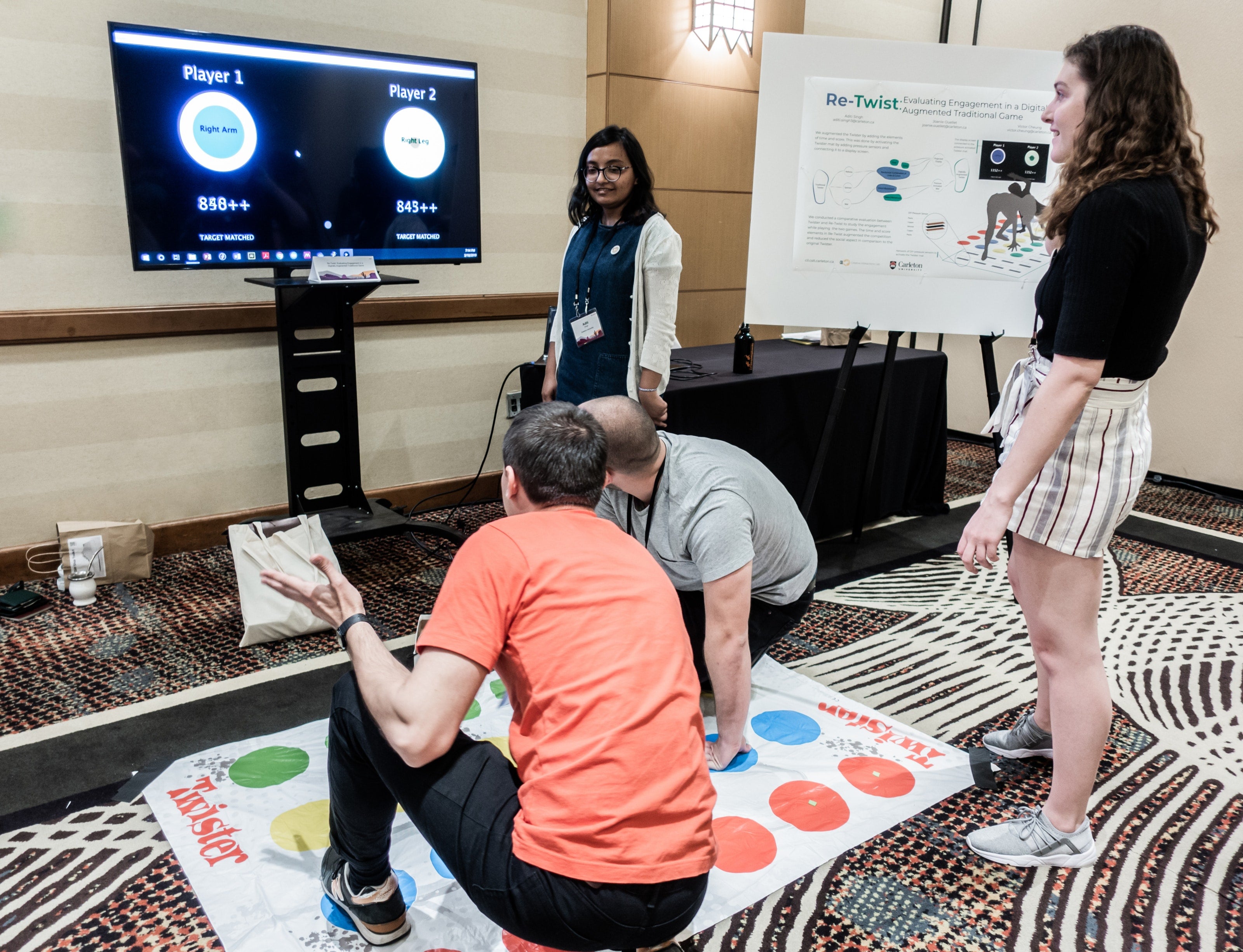 Two people using Re-twist - a digitally augmented version of the traditional game