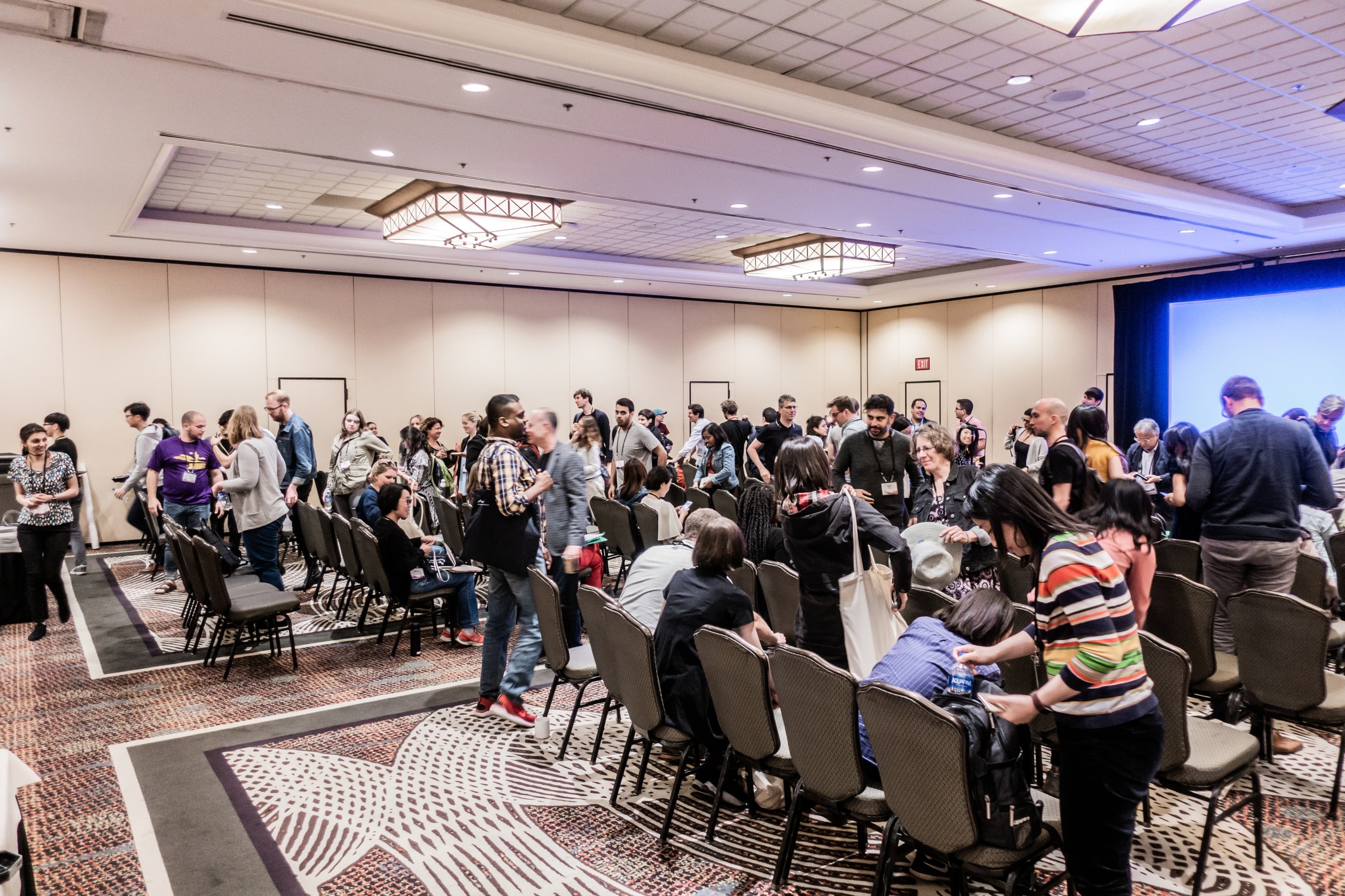 People gathering into main conference room