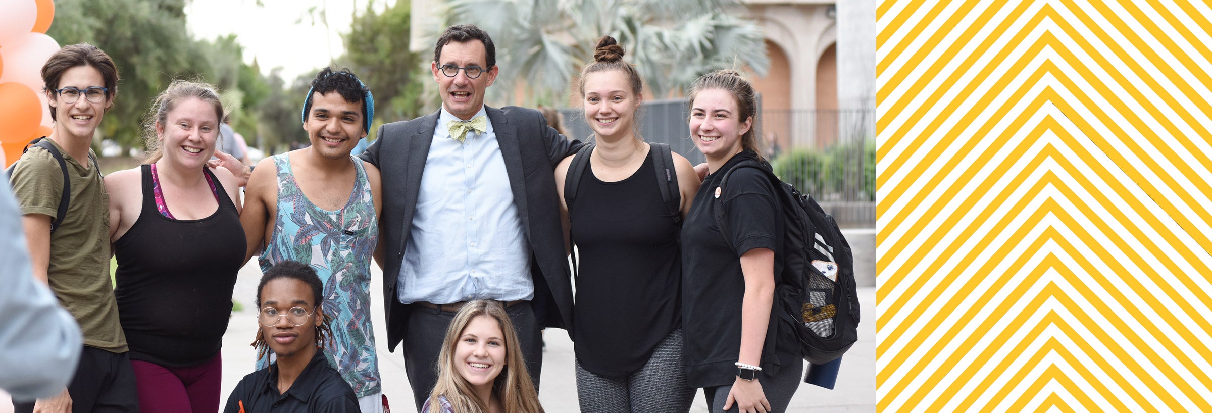 Dean Steven Tepper taking group photo with several students