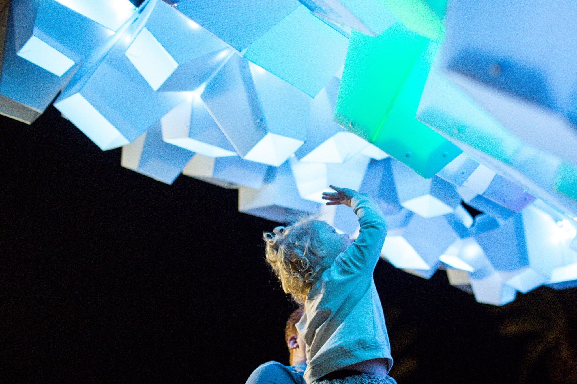 child interacting with art installation